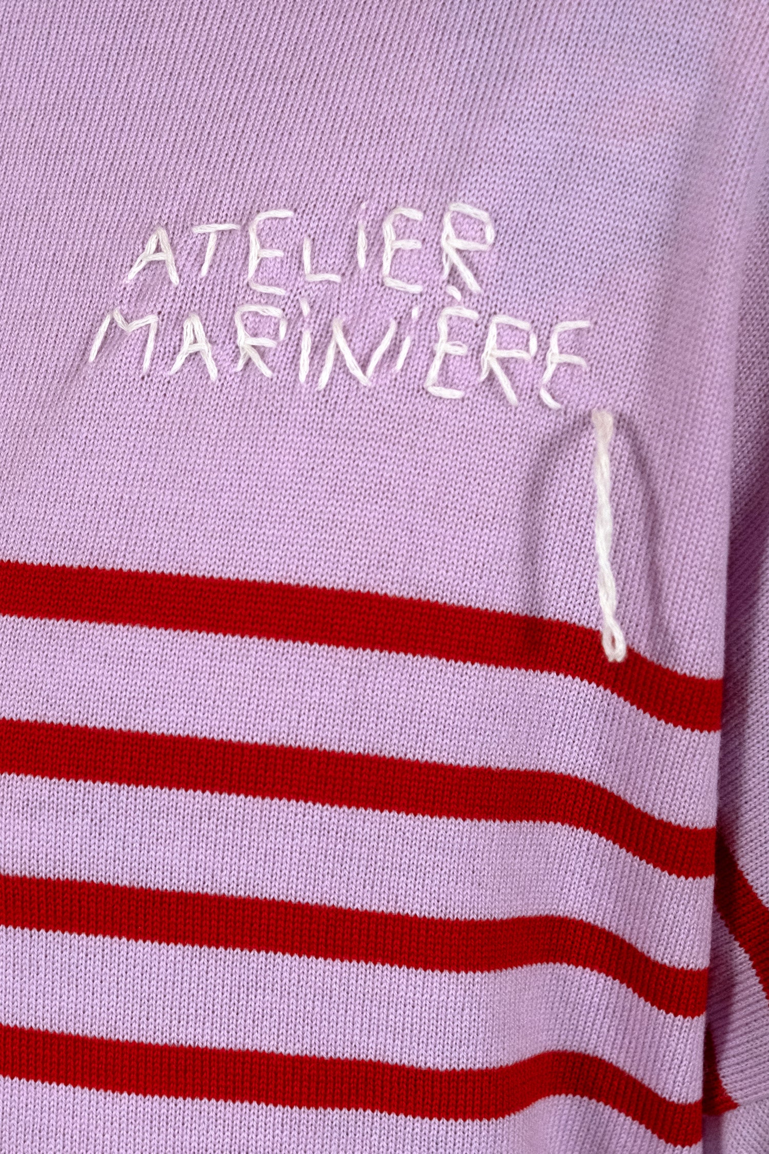 Close-up of the pink and red stripes on the merino wool Breton Shirt, soft and thermo-regulating fabric, ideal for a casual chic look