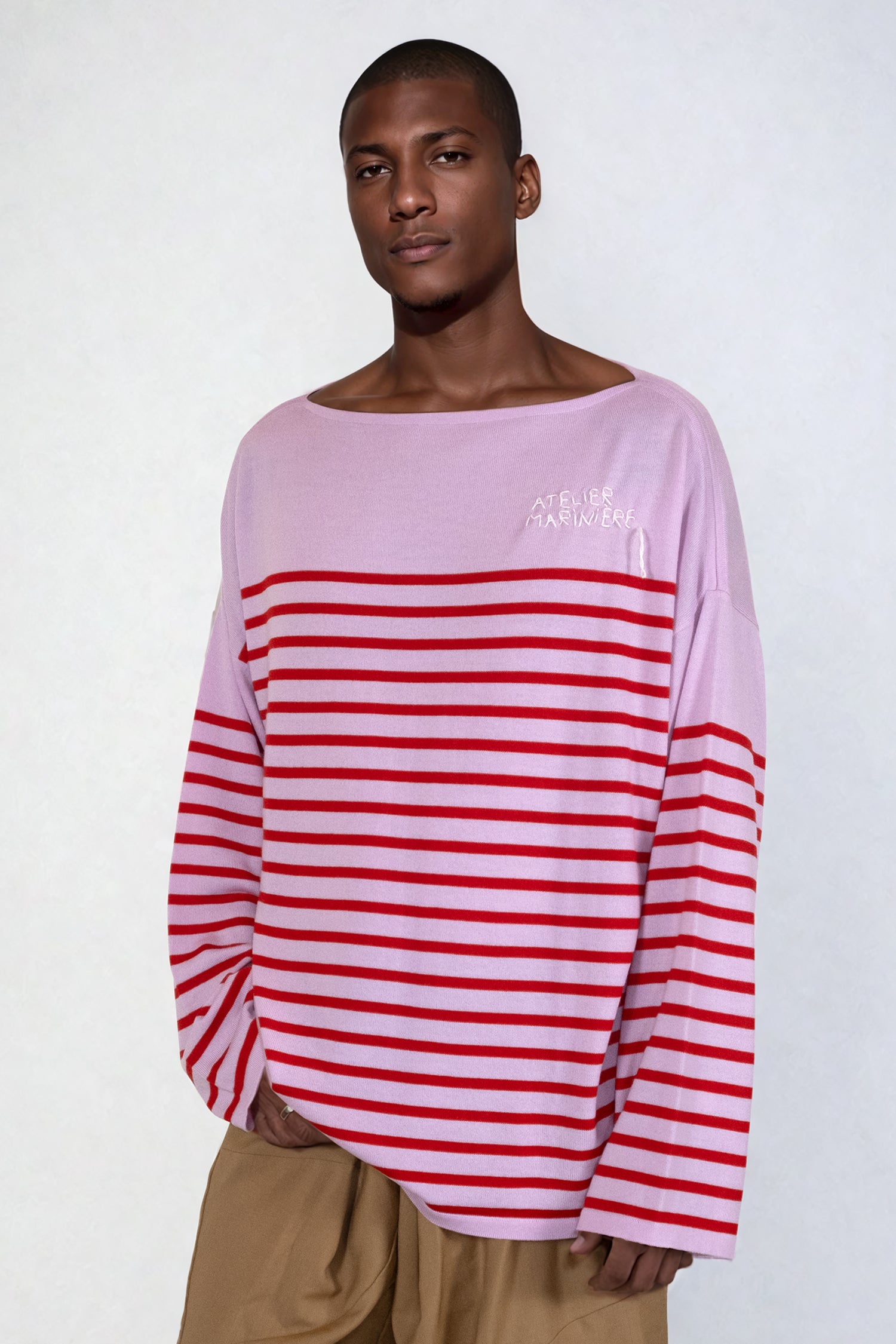 Model wearing the pink and red Breton Shirt, French-inspired style, perfect for day-to-night outfits
