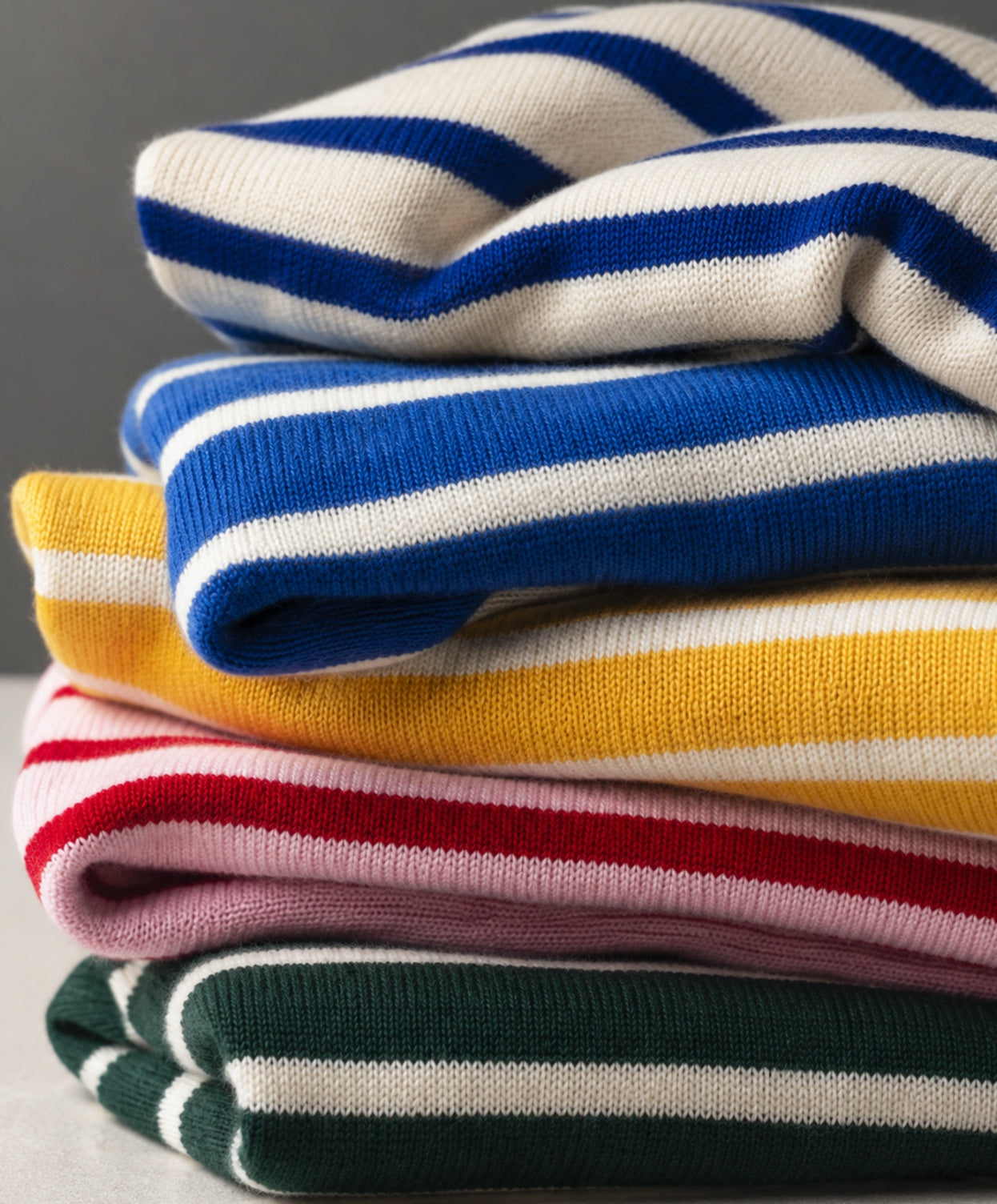 Folded Breton shirts by Atelier Marinière in different colours, handcrafted in Italy from premium cotton.