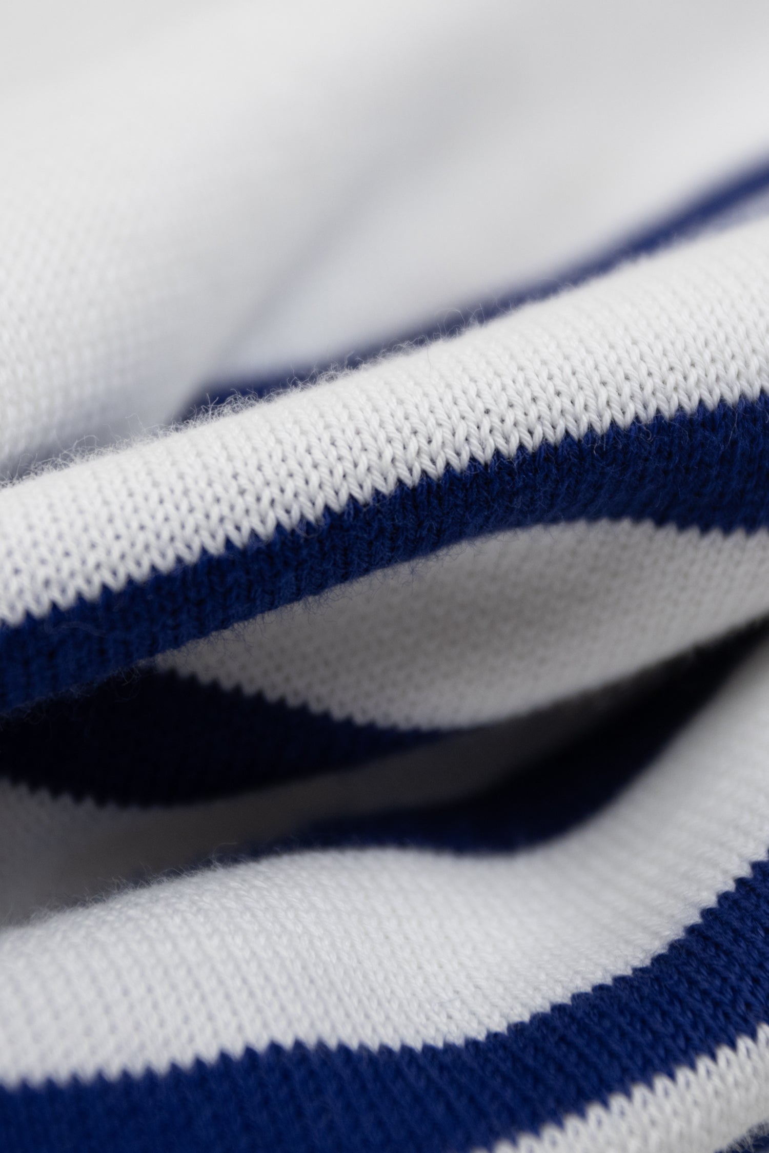 Close-up of the Atelier Marinière Breton shirt in 100% cotton, showcasing the fine Italian knit and signature navy and white stripes